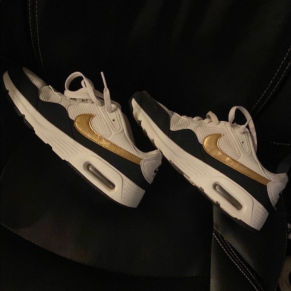 Nike Air Sneakers with Black, White, and Gold Accents BX1